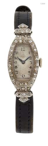 A lady's Art Deco platinum and diamond wristwatch, the tonneau shaped dial with Arabic numerals to