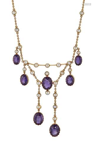 An Edwardian gold, amethyst and half-pearl necklace, the swag front with central oval amethyst and