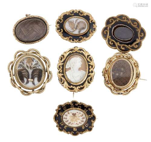 A group of seven 19th century gilt-mounted mourning brooches, comprising: four enamel examples,