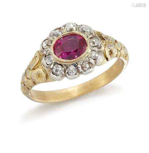 A ruby and diamond cluster ring, the central closed-set oval ruby within a closed-set old-cut