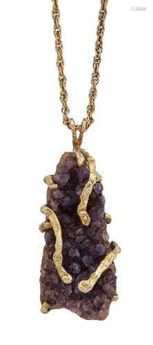 A 9ct gold and amethyst crystal pendant, the freeform amethyst crystal formation in abstract claw