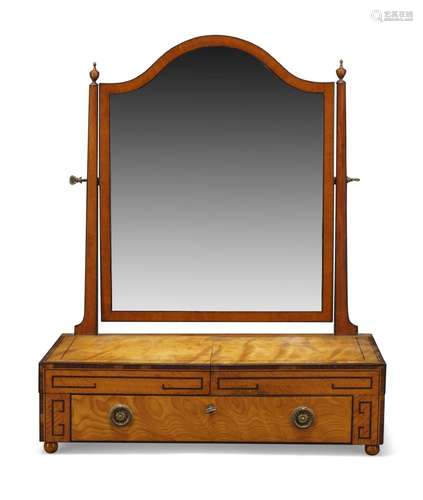 A Regency satinwood toilet mirror, the shaped mirror between square tapering supports with urn