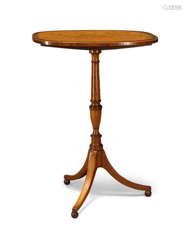 A George III satinwood and crossbanded tilt-top occasional table, the rounded oblong top on turned