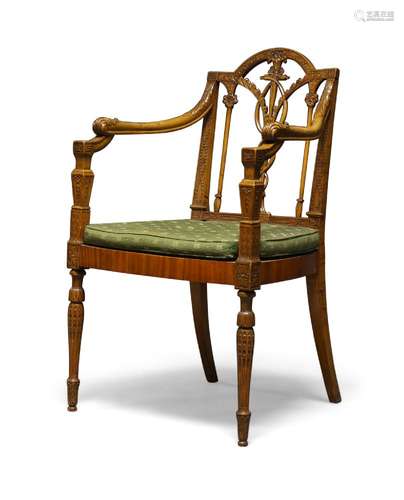 An Edwardian carved beech and satinwood veneered armchair, with caduceus splat back over cane