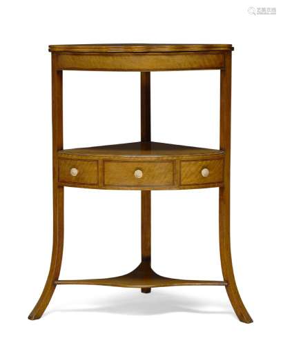 A George III Sheraton-style satinwood three-tier corner washstand, with hinged folding top, above