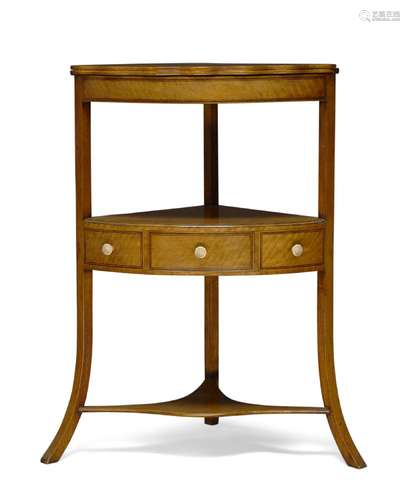 A George III Sheraton-style satinwood three-tier corner washstand, with hinged folding top, above