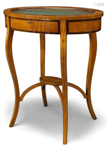 An Edwardian satinwood and inlaid oval vitrine table, the glazed hinged top with green fabric