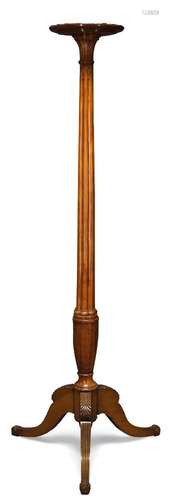 A satinwood dish-top torchère stand, late 19th/ early 20th Century, the circular top on reeded