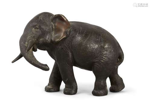 A small Japanese bronze elephant, Meiji Period, standing with head turned, 13cm high.Please refer to