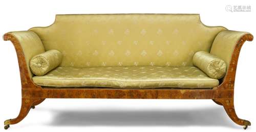 A Regency satinwood and floral painted sofa, with shaped back and scrolled ends, upholstered in