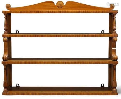 A set of Victorian satinwood hanging shelves, the shaped pediment with scrolling ends and applied