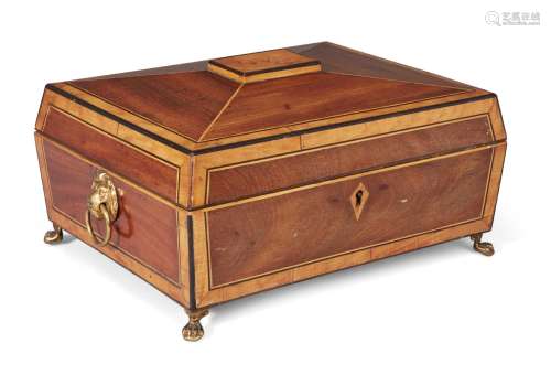 A Regency satinwood sarcophagus needlework box, the top opening to a fitted interior, on brass