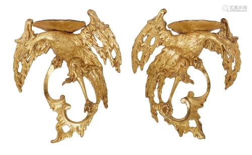 A pair of George II giltwood and gesso Ho-Ho bird wall brackets, each with a shell plateau on the