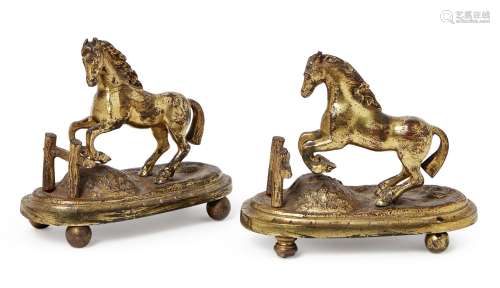 A pair of mid-19th Century cast brass menu holders, each in the form of a jumping horse, on oval