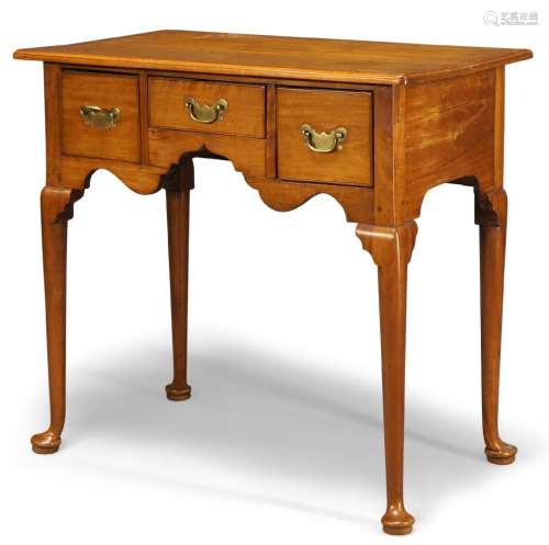 A fruitwood lowboy, mid 18th Century and later, the rectangular top above three frieze drawers and