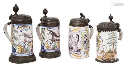 Four 18th century German polychrome faience tankards, each with pewter mounts, painted landscape