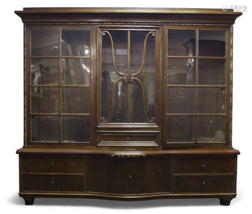 A German mahogany triple bookcase, early 20th Century, the moulded cornice above three glazed