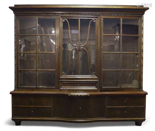 A German mahogany triple bookcase, early 20th Century, the moulded cornice above three glazed