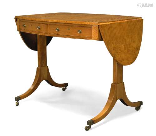 A Regency satinwood oval sofa table, with opposing pairs of real and faux frieze drawers, on