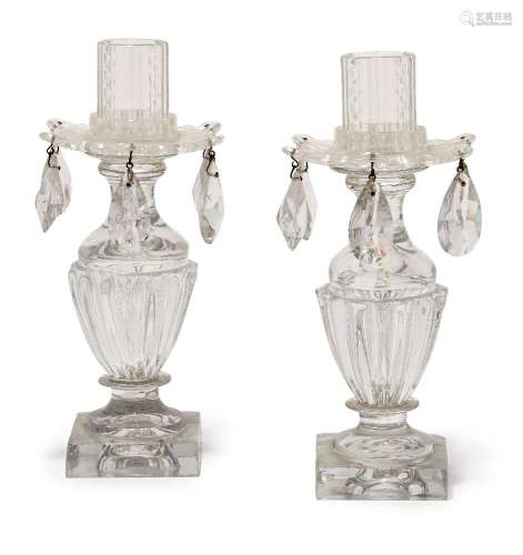 A pair of Regency Irish lustre drop urn shape candlesticks, the fluted sides raised on square