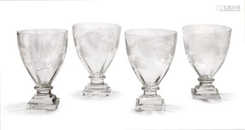 A set of four Regency cut glass rummers, engraved hops and barley, raised on stepped square bases,