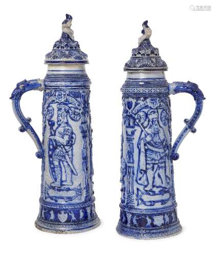 A pair of 19th century German blue tall steins, lids with figural finials, the bodies decorated with