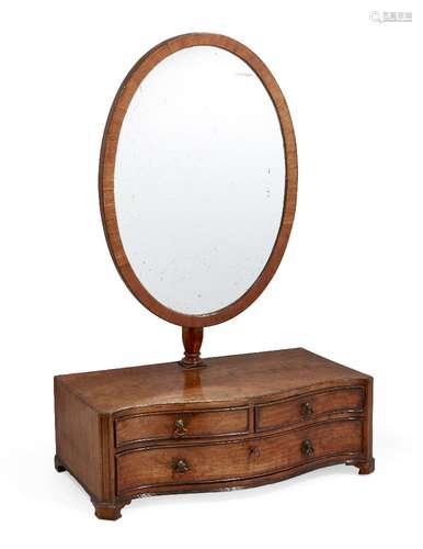 A George III satinwood serpentine front oval toilet mirror, with oblique hung mirror and three