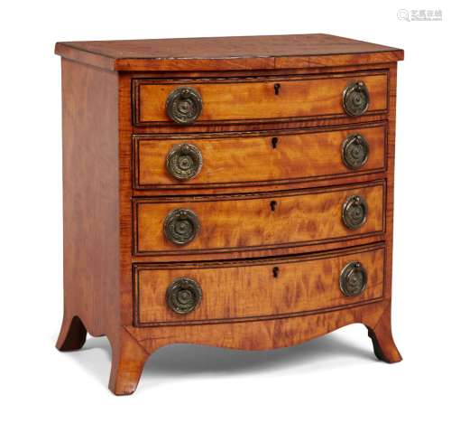 A Regency satinwood miniature bow-fronted chest, the four long drawers inlaid with ebony stringing