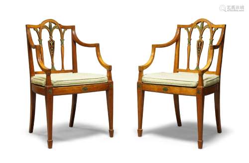 A pair of George III painted satinwood armchairs, with vase shaped back splat, over woven cane