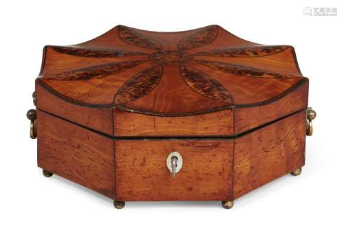 A George III satinwood octagonal box, of “batwing” shape, the shaped top with burr wood flower