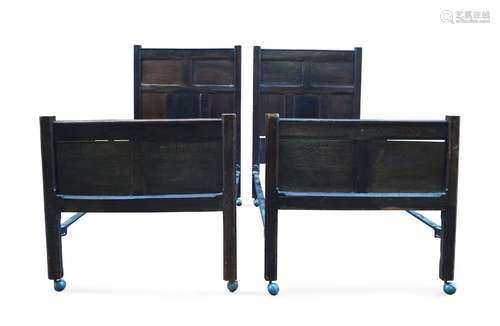 A pair of oak single beds, late 19th century, incorporating earlier elements, with panelled