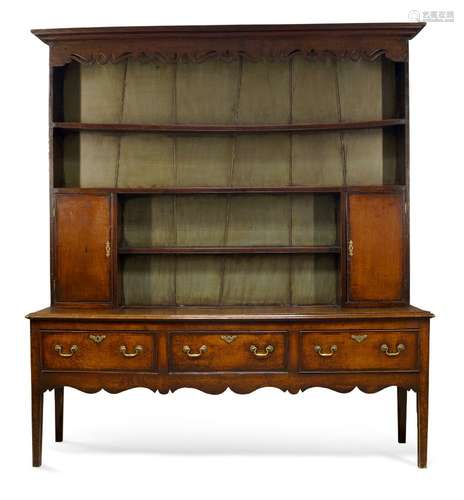 A George III oak dresser, the plate rack with moulded cornice over shaped and pierced apron and