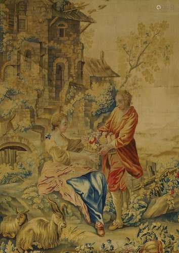 A Louis XV Beauvais tapestry, mid 18th century, depicting pastoral figures with fruit, a building