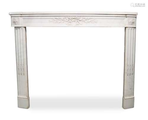 A white marble fireplace, late 19th/early 20th century, the bow front shelf above frieze with carved