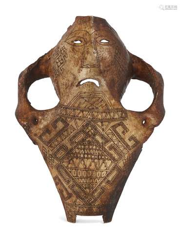 An Indonesian Belu-Atoni cow skull mask, incised all-over with geometric designs, 25cm long