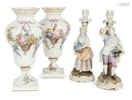 A pair of Austrian porcelain urns and a pair of German porcelain figural candlesticks, late 19th