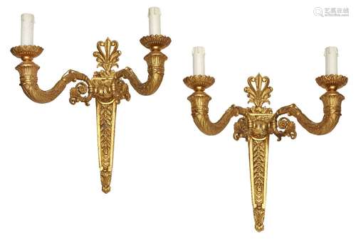 A pair of bronze and gilt bronze twin branch wall lights, 20th Century, designed with scrolling