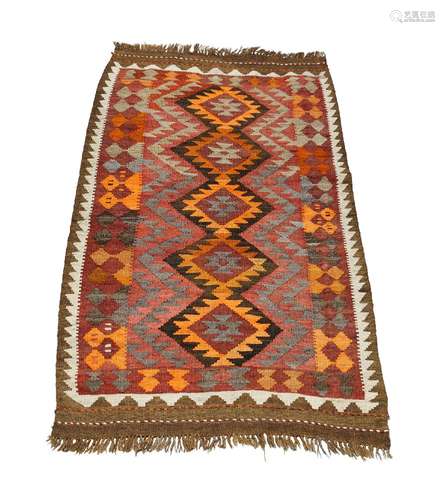 A Caucasian Kilim, mid to late 20th century, with five medallions in brick red field, 167cm x