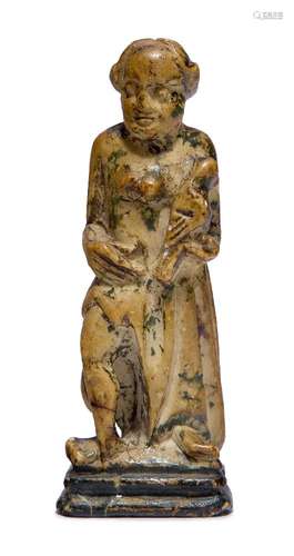 A carved alabaster figurine of a female saint holding a dove, possibly Hispano-Filipino in origin,