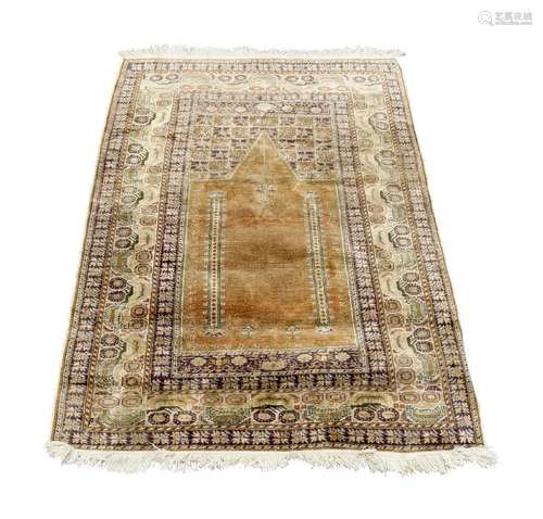 A West Persian silk prayer rug, mid to late 20th century, with Mihrab field, enclosed by ivory