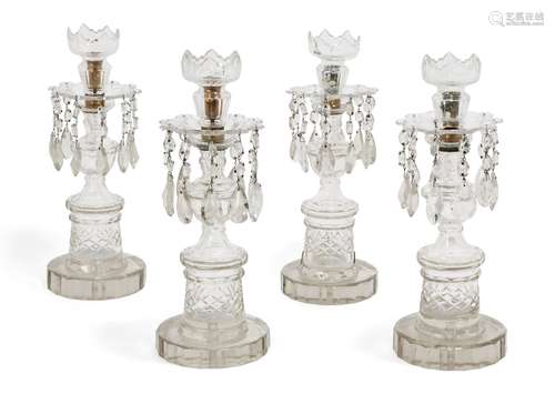 A set of four Regency clear cut-glass candlesticks, with crenulated sconces and teardrop lustres