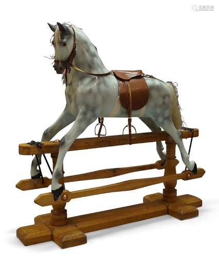 A dapple grey painted rocking horse, late 20th century, the horse with leather saddle and bridle,