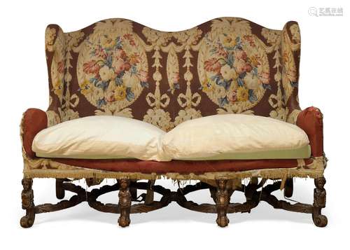 A William and Mary style sofa, first half 20th century, with serpentine shaped back and wing arms,