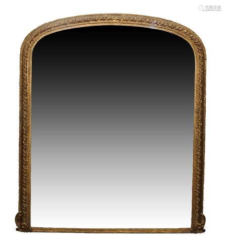 A large gilt overmantle mirror, late 19th century, of arched form with spiral motif and stiff leaf