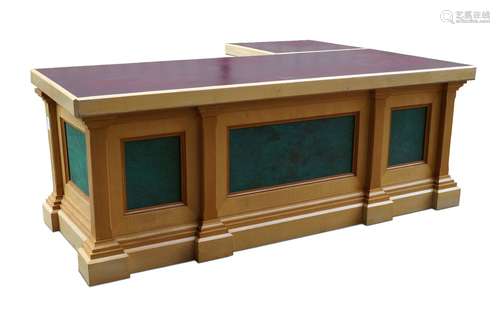 A modern L-shaped desk, late 20th century, the top inset with burgundy laminate writing surface on