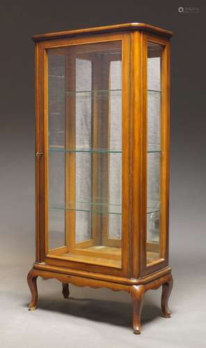 A stained beech and glazed vitrine, early 20th century, with single glazed door, enclosing mirror