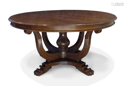 A William IV style mahogany dining table, late 20th century, the circular top on central carved