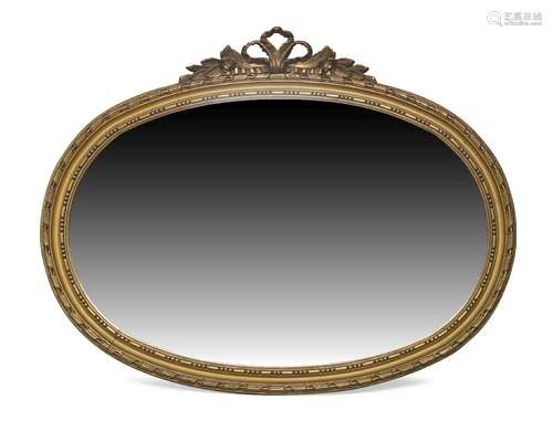 An gilt overmantle mirror, late 20th century, of oval form with pierced ribbon and and foliate