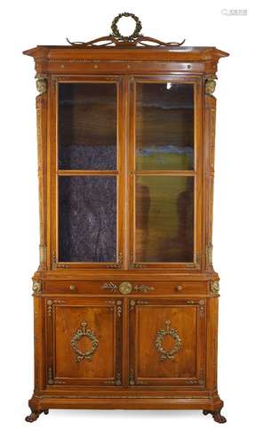 A French Directoire style walnut and parcel gilt display cabinet, 20th century, the moulded