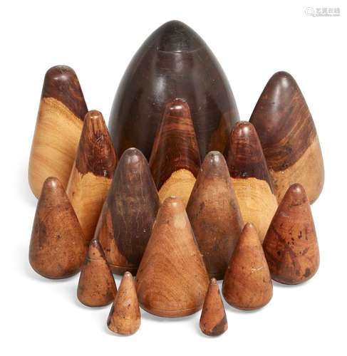 A group of fifteen lignum vitae and treen metalworker's blocks, 19th century and later, of conical